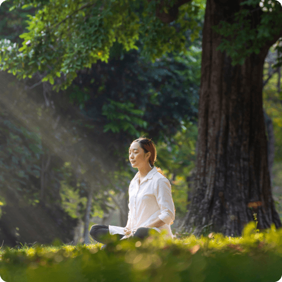 woman having mediation from sun under the tree