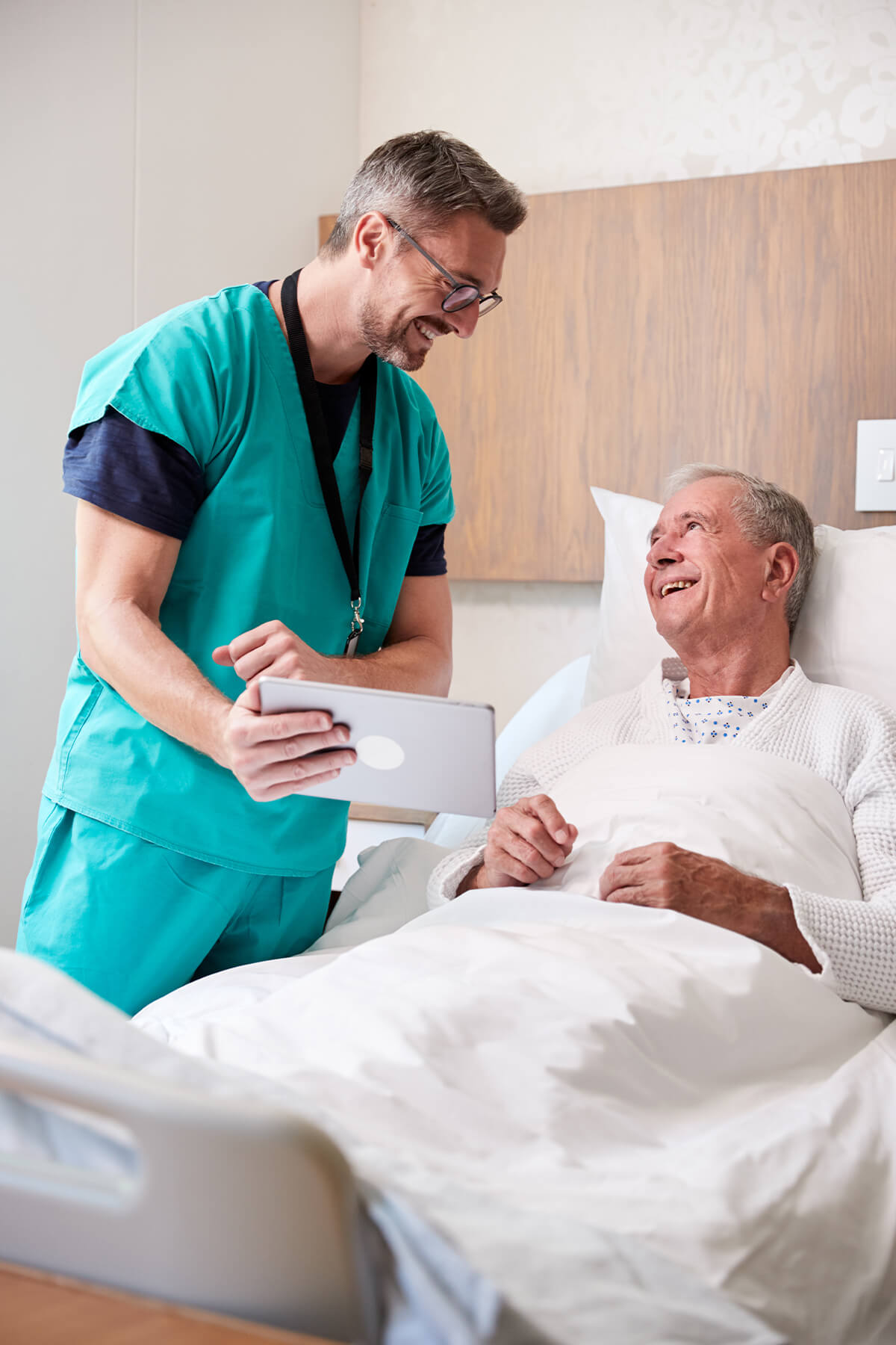 hospital staff and patient looking happily at each other