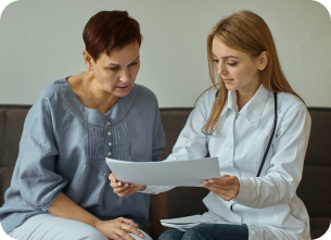 female doctor explaining to an elderly patient