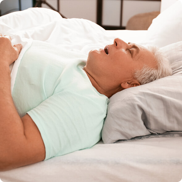 old man sleeping on a bed