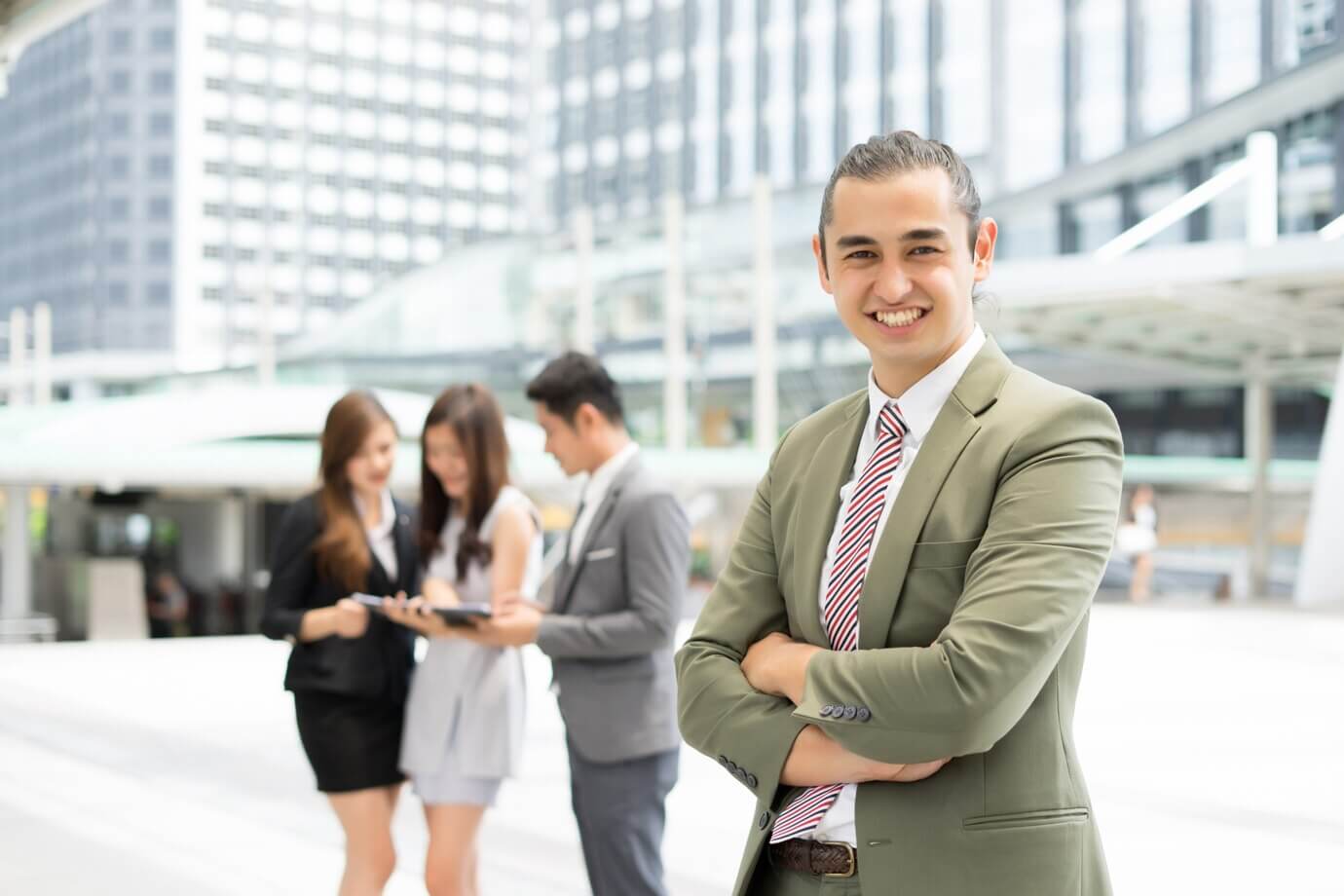 portrait-businessman-standing-against-building-outdoors